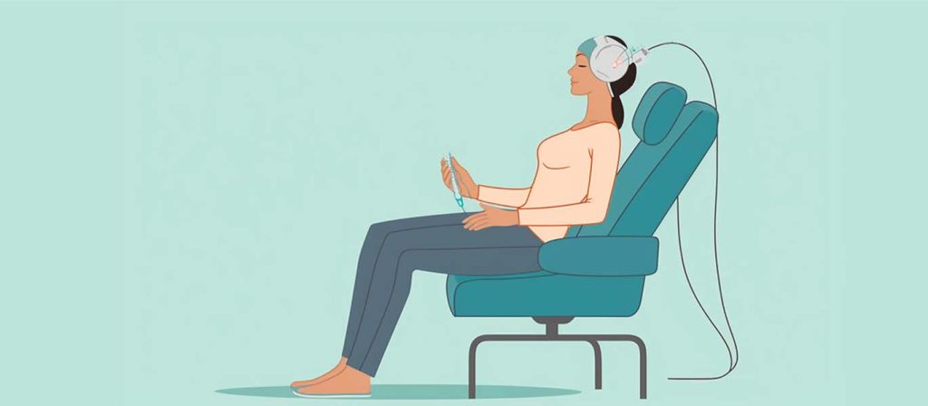 Person sitting in chair with a tACS device treating them